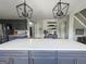 Modern kitchen boasts a large island, gray cabinetry, stainless steel appliances, and stylish lighting fixtures at 184 Fashion Xing, Mcdonough, GA 30252