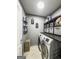 Functional laundry room featuring a washer and dryer, storage shelves, and ample counter space at 184 Fashion Xing, Mcdonough, GA 30252