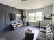 Stylish living room with a statement wall, modern decor, and dark floors for a comfortable setting at 184 Fashion Xing, Mcdonough, GA 30252