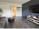 Cozy living room features dark wood floors, TV, and ample storage space for comfortable living at 184 Fashion Xing, Mcdonough, GA 30252