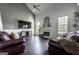 Spacious living room featuring hardwood floors, a fireplace, and comfortable seating for entertaining guests at 184 Fashion Xing, Mcdonough, GA 30252