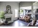Cozy living room featuring a fireplace, elegant decor, and stylish leather furniture at 184 Fashion Xing, Mcdonough, GA 30252