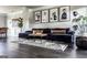 Elegant living room with hardwood floors, stylish rug, and black and white portrait artwork at 184 Fashion Xing, Mcdonough, GA 30252