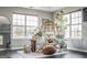 Light-filled sitting area with a rattan chair, soft textures, and various plants to add greenery at 184 Fashion Xing, Mcdonough, GA 30252