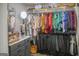 Well-organized walk-in closet with a vanity area, clothing racks, and a shelf for bags at 184 Fashion Xing, Mcdonough, GA 30252