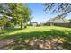 Large, grassy backyard features a detached storage building, privacy fence, and mature trees at 603 Rossie Court, Mcdonough, GA 30252