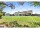 Large, grassy backyard features a detached storage building, privacy fence, and mature trees at 603 Rossie Court, Mcdonough, GA 30252