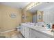 Bathroom featuring a double vanity, a toilet, and a shower with fish-themed wall decor at 603 Rossie Court, Mcdonough, GA 30252