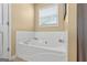 A white, built-in tub next to a window at 603 Rossie Court, Mcdonough, GA 30252