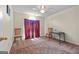 Empty carpeted bedroom with natural light and red curtains at 603 Rossie Court, Mcdonough, GA 30252