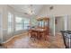 Dining room features large windows, a classic wood table with chairs, and a beautiful china cabinet at 603 Rossie Court, Mcdonough, GA 30252