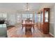 Dining room features large windows and a classic wood table with chairs at 603 Rossie Court, Mcdonough, GA 30252