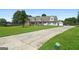 Home with a well-maintained lawn, long driveway, and detached garage under a blue sky at 603 Rossie Court, Mcdonough, GA 30252