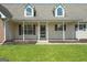 Close-up of the front porch with white pillars and shuttered windows at 603 Rossie Court, Mcdonough, GA 30252