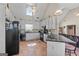 Bright kitchen featuring vaulted ceilings, white cabinetry, black appliances, and a breakfast bar with seating at 603 Rossie Court, Mcdonough, GA 30252