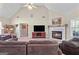 Living room features a fireplace, large TV, and neutral carpet at 603 Rossie Court, Mcdonough, GA 30252