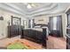 The main bedroom has a spacious layout, a tray ceiling, and a green-toned carpet at 603 Rossie Court, Mcdonough, GA 30252