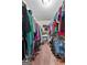 Organized walk-in closet with shelves and hanging clothes at 603 Rossie Court, Mcdonough, GA 30252