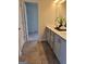 Bathroom featuring double vanity, grey cabinets, and tiled floor, providing a sleek and modern design at 45 Oak Wood Lane, Covington, GA 30016