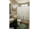 A charming bathroom includes a vanity, toilet, and shower-tub combo at 45 Oak Wood Lane, Covington, GA 30016