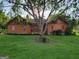 Charming home with a tree-filled yard and inviting front entrance at 45 Oak Wood Lane, Covington, GA 30016