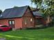 The side of this home features a door to the backyard and mature landscaping at 45 Oak Wood Lane, Covington, GA 30016