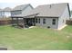 Spacious backyard featuring a covered patio, perfect for outdoor entertaining and relaxation at 4605 Dandelion Way, Cumming, GA 30040