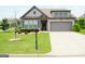Charming single-Gathering home featuring a well-manicured lawn and an attached two-car garage at 4605 Dandelion Way, Cumming, GA 30040