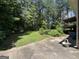 Spacious backyard with lush green lawn and mature trees, perfect for outdoor activities at 5277 Scofield Rd, South Fulton, GA 30349