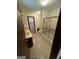 Bathroom with sink vanity and shower featuring patterned wallpaper at 5277 Scofield Rd, South Fulton, GA 30349
