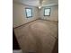 Empty bedroom featuring carpet, two windows, and a ceiling fan with light at 5277 Scofield Rd, South Fulton, GA 30349
