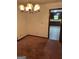 Charming dining area with vintage chandelier and view into the retro kitchen at 5277 Scofield Rd, South Fulton, GA 30349