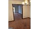 Carpeted dining room with chandelier and white walls, offering a blank canvas for customization at 5277 Scofield Rd, South Fulton, GA 30349