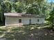 Side view of the exterior with two windows, one door and horizontal siding at 5277 Scofield Rd, South Fulton, GA 30349