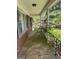 Spacious covered front porch with stone flooring, supported by white columns and black iron railings at 5277 Scofield Rd, South Fulton, GA 30349