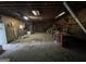 Garage featuring exposed rafters, storage shelves, work benches, and concrete floor at 5277 Scofield Rd, South Fulton, GA 30349