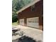 Attached two-car garage with white doors and a brick exterior at 5277 Scofield Rd, South Fulton, GA 30349