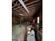 Large garage interior with exposed rafters, work benches, and some clutter at 5277 Scofield Rd, South Fulton, GA 30349