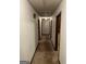 Hallway with multiple doors and carpet, leading to different rooms in the home at 5277 Scofield Rd, South Fulton, GA 30349