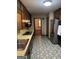 Vintage kitchen with stainless appliances, laminate countertops, retro flooring and wood cabinetry at 5277 Scofield Rd, South Fulton, GA 30349