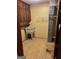 Laundry room featuring a utility sink and wooden cabinets for storage at 5277 Scofield Rd, South Fulton, GA 30349