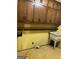 Close-up of a laundry room with a utility sink, wooden cabinets, and shelf at 5277 Scofield Rd, South Fulton, GA 30349