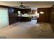 Open floor plan living room connecting to the kitchen with wooden paneling and stone fireplace at 5277 Scofield Rd, South Fulton, GA 30349