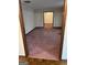 View of large room with carpet flooring and view into dining area at 5277 Scofield Rd, South Fulton, GA 30349
