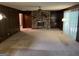 Spacious living room featuring a stone fireplace, built-in shelving, and wood paneling at 5277 Scofield Rd, South Fulton, GA 30349