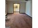 Bright living room with carpet floors and white walls, featuring ample space and natural light at 5277 Scofield Rd, South Fulton, GA 30349
