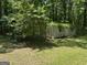 Exterior view of a shed surrounded by lush greenery and mature trees at 5277 Scofield Rd, South Fulton, GA 30349