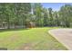 Fenced backyard with mature trees and a storage shed at 100 Walnut Ct, Stockbridge, GA 30281