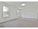 Bedroom features neutral carpet, two large windows, and light, airy atmosphere at 100 Walnut Ct, Stockbridge, GA 30281