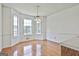 Bright dining area with large windows and wooden floors, adjacent to the kitchen at 100 Walnut Ct, Stockbridge, GA 30281